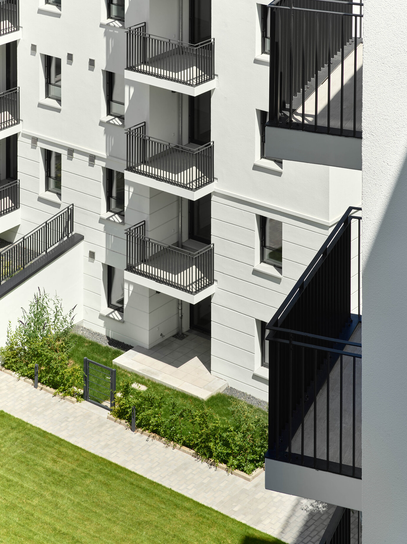 Extended balconies are forming open spaces with view of the garden courtyard.